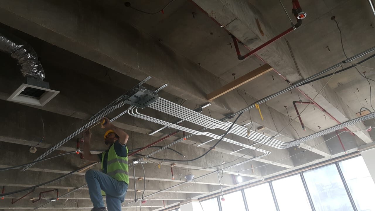 Electrician installing an electrical distribution panel